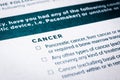 Close up cancer content on health insurance questionnaire