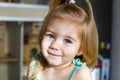 Close up candid lifestyle portrait of lovely blond little girl in sunlight in the morning