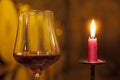 Close-up of a candle and a glass with red wine in a wine cellar Royalty Free Stock Photo