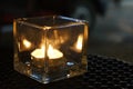 A candle burning in a crystal support