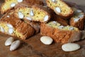 Close-up on cantucci or cantuccini on wooden background with shelled almonds. Cantuccini are typical Tuscan dry biscuits, made
