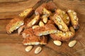 Close-up on cantucci or cantuccini on wooden background with shelled almonds. Cantuccini are typical Tuscan dry biscuits, made