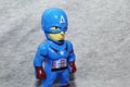 Close up Captain America`s toys a gray background