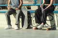 Close up caption to the feet of Skate boarders resting in the skate park. Unrecognizable people Royalty Free Stock Photo