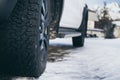 Close-up on car all-terrain winter tires on the snowy road Royalty Free Stock Photo