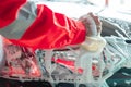 Close up of car cleaner hands in red uniforms cleaning car windows with a foamy sponge Royalty Free Stock Photo