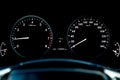 Close-up of a car dashboard with a tachometer and speedometer indicating fuel level and measuring engine speed and speed against a Royalty Free Stock Photo