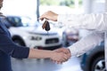 Close-up of car dealer shaking buyer`s hand and giving keys afte Royalty Free Stock Photo