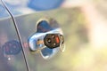 Close up of car door with key sticking out of the lock. Concept of process opening or closing vehicle Royalty Free Stock Photo