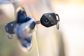 Close up of car door with key sticking out of the lock. Concept of process opening or closing vehicle Royalty Free Stock Photo