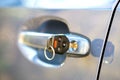 Close up of car door with key sticking out of the lock. Concept of process opening or closing vehicle Royalty Free Stock Photo