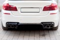 Close up of a car dual exhaust pipe Royalty Free Stock Photo