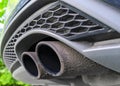 Close up of a car dual exhaust pipe. Double exhaust pipes of a modern sports car. Car exterior details Royalty Free Stock Photo