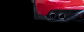 Close up of a car dual exhaust pipe. Double exhaust pipes of a red modern sports car. Car exterior details. New car parts with