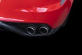 Close up of a car dual exhaust pipe. Double exhaust pipes of a red modern sports car. Car exterior details. New car parts with