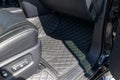 Close-up car floor mats of luxury leather, interior trim with white diamond stitching Royalty Free Stock Photo