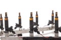 Close-up on a car fuel rail with injectors for supplying gasoline to eight cylinder engine on a white isolated background. Spare