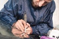 Close up Car glaze worker fixing and repairing a windshield or windshield of a car at a garage service station. Drill Royalty Free Stock Photo