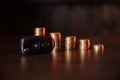 Close-up of car key in front of coins stacked on wooden table. Saving money concept Royalty Free Stock Photo