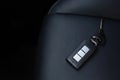 Close up of a car key ring and remote control alarm system or Forget keys placed on the leather seats Royalty Free Stock Photo