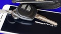 Close up car keys and cell phones with blue background Royalty Free Stock Photo