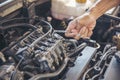 Close up Car Mechanic man hands repairing car auto repair shop. Man hands fixing machinery vehicle mechanical service. open Royalty Free Stock Photo