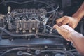 Close up Car Mechanic man hands repairing car auto repair shop. Man hands fixing machinery vehicle mechanical service. open Royalty Free Stock Photo