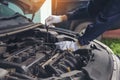 Close up Car Mechanic man hands repairing car auto repair shop. Man hands fixing machinery vehicle mechanical service. open Royalty Free Stock Photo