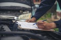 Close up Car Mechanic man hands repairing car auto repair shop. Man hands fixing machinery vehicle mechanical service. open Royalty Free Stock Photo