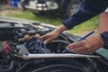 Close up Car Mechanic man hands repairing car auto repair shop. Man hands fixing machinery vehicle mechanical service. open Royalty Free Stock Photo