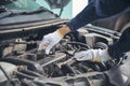 Close up Car Mechanic man hands repairing car auto repair shop. Man hands fixing machinery vehicle mechanical service. open Royalty Free Stock Photo