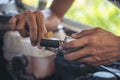 Close up Car Mechanic man hands repairing car auto repair shop. Man hands fixing machinery vehicle mechanical service. open Royalty Free Stock Photo