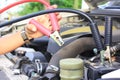 Close-Up Car mechanic uses battery jumper cables to car battery Royalty Free Stock Photo