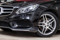 Close-up on a car Mercedes E-class body standing inthe garage box for polishing and removing scratches from the surface. Auto