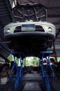 Car on a service lift in a garage.