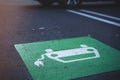 close up on car symbol with cable plug painted in green and white at a public parking lot. Royalty Free Stock Photo