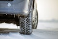 Close up of a car tire parked on snowy road on winter day. Transportation and safety concept Royalty Free Stock Photo