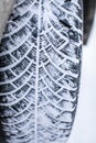 Close up car tires covered with snow. Winter tyres in extreme cold temperature Royalty Free Stock Photo