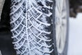 Close up car tires covered with snow. Winter tyres in extreme cold temperature Royalty Free Stock Photo