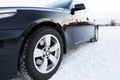 Close up of car tires on the winter road Royalty Free Stock Photo