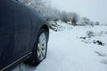 Close-up of car tires in winter on snow-covered road Royalty Free Stock Photo