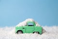 Close up of car toy covered with snow after winter storm abstract on pastel blue background Royalty Free Stock Photo