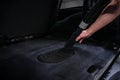 Close up of car wash worker hoovering car trunk. Car wash cleaning services Royalty Free Stock Photo