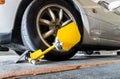 Close-up of Car wheel blocked by wheel lock because illegal parking violation