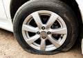 Close up car wheel flat tire on the road.