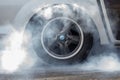 Close up car wheel with smoke on the asphalt road speed track, Car wheel drifting and smoking on track, Car wheel spinning Royalty Free Stock Photo