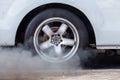 Close up car wheel with smoke on the asphalt road speed track, Car wheel drifting and smoking on track, Car wheel spinning Royalty Free Stock Photo
