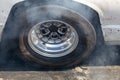 Close up car wheel with smoke on the asphalt road speed track, Car wheel drifting and smoking on track, Car wheel spinning Royalty Free Stock Photo