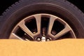 Close up of a car wheel stuck in the sand in the desert Royalty Free Stock Photo