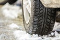 Close-up of car wheel in winter tire on snowy road Royalty Free Stock Photo